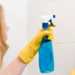 woman cleaning the bathroom tiles