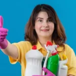 woman with a bucket full of cleaning products