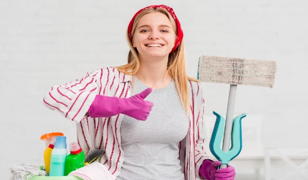 Woman with cleaning products showing ok sign