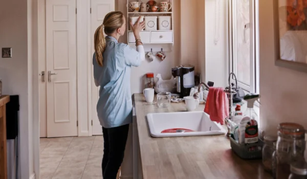 Spring cleaning kitchen and woman cleaner doing house work in a home for hygiene housekeeper